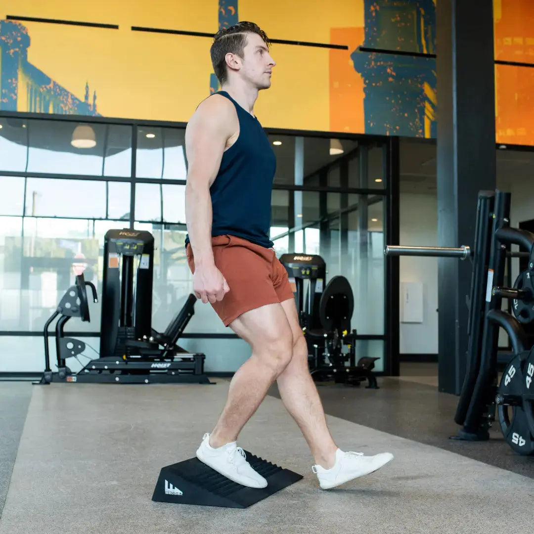 Perform step downs on our anti slip slant board, squat wedge by SquatWedgiez